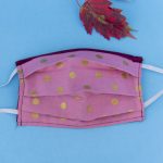Elastic face mask. Metallic polka dots on pink fabric.