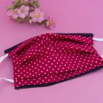 Face covering with elastics. Red with polka dots.
