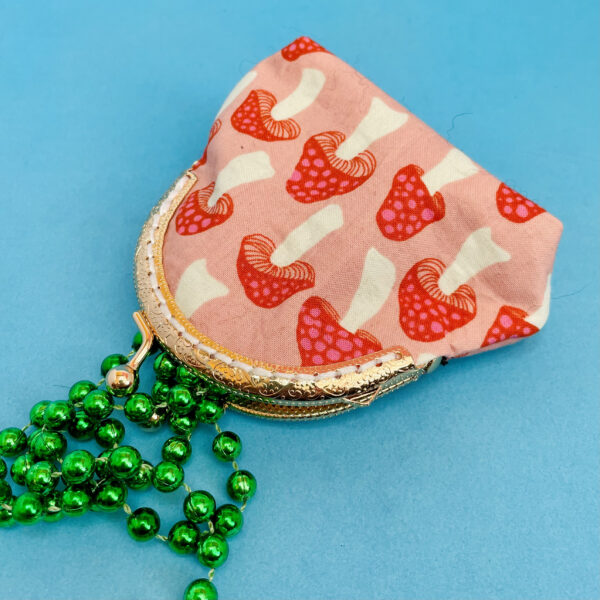 Coin purse with pink and red mushrooms.